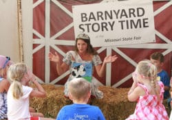 2021 Missouri State Fair Queen, Rosie Lenz, reading a story to kids at Barnyard Story Time