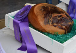 A ham with a purple grand champion ribbon