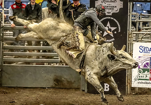 A bull rider competing at the Missouri State Fair