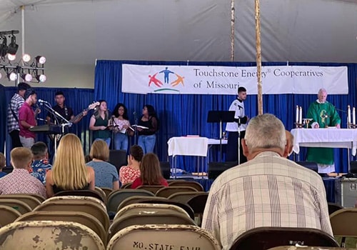 Fair goers attending catholic mass at the fair.