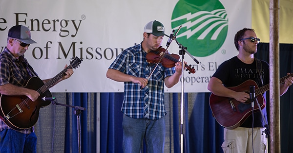 Three men participating in the fiddling contest