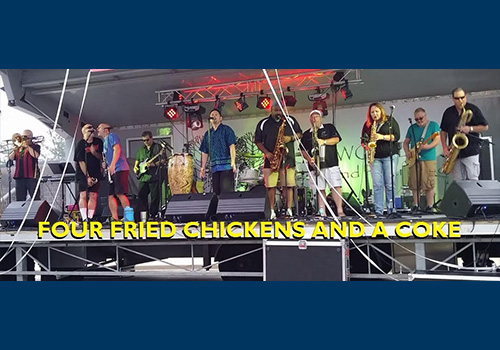 Four Fried Chickens & A Coke playing on a stage outside