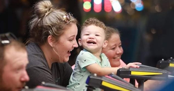 A mom and young boy on a carnival ride