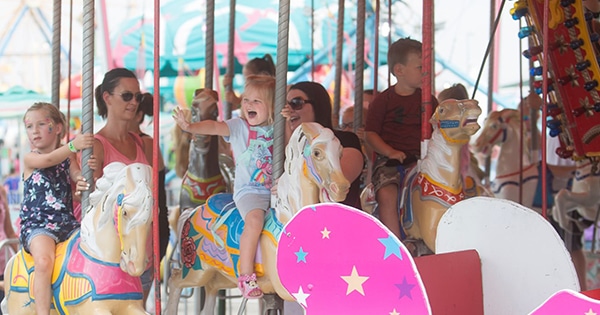 Children riding a carousel