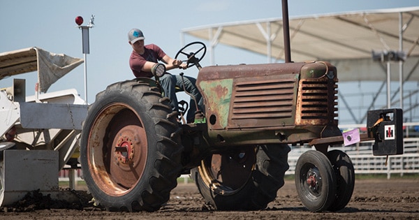 A man participating on a tractor pull