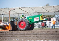 A tractor competing in the tractor pull at the Missouri State Fair arena