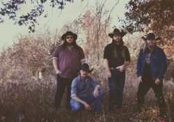 Steven Bankey band members standing on the edge of a field