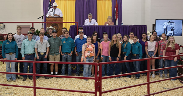 A group of kids standing in front of a stage